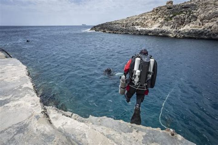 Diver Comes Up From Jacobs Well