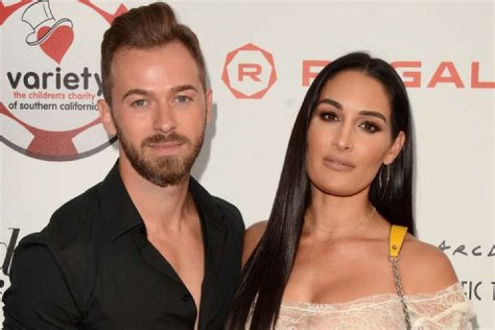 Nikki Bella posing with Artem Chigvintsev ahead of Dancing with the Stars